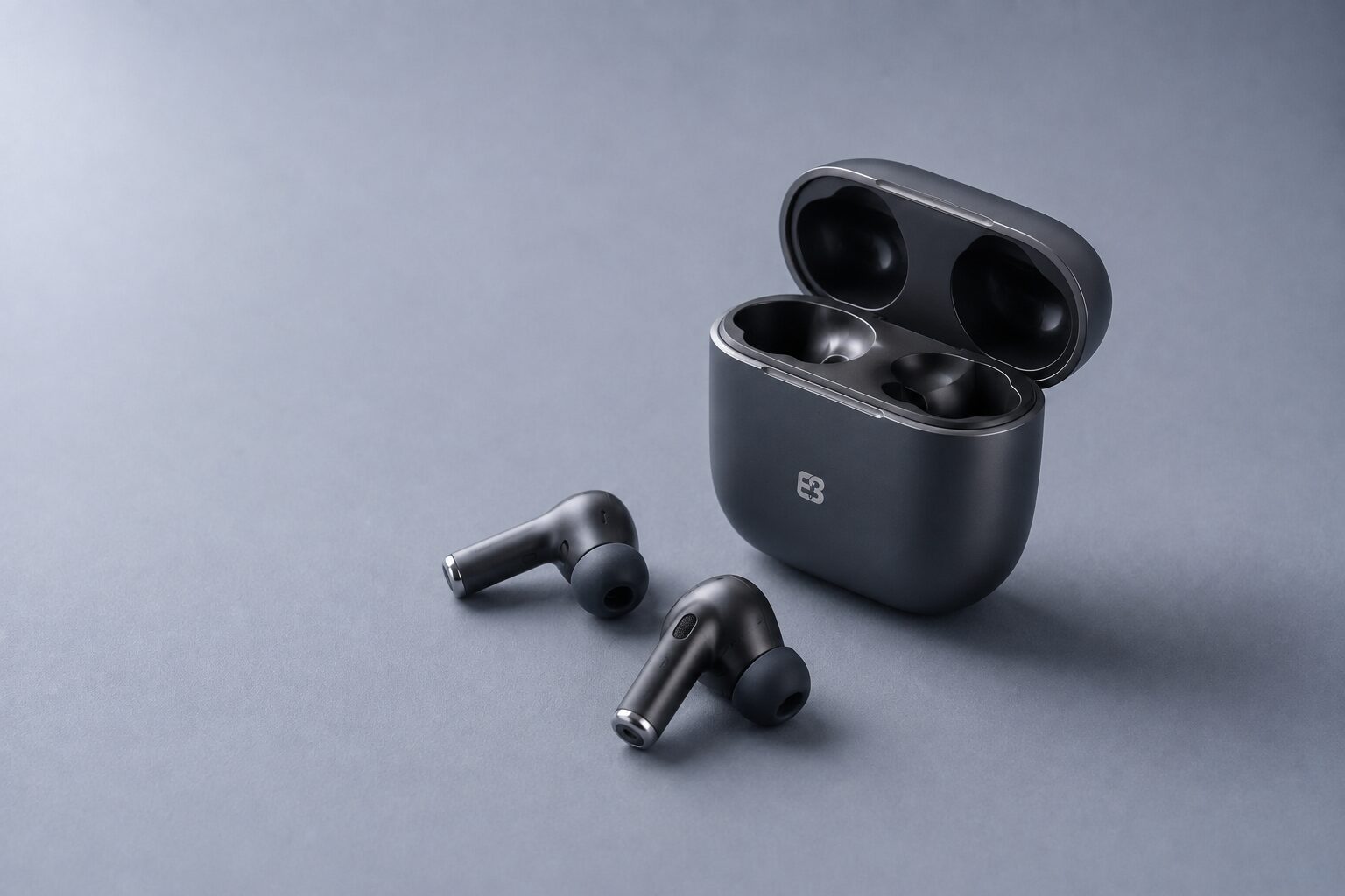 Graphite ANC true wireless earbuds with silicone tips and an open EarbudSource branded charging case